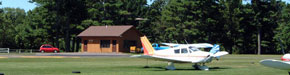 Picture of airplanes and an arrival departure building.