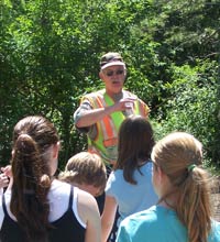 Man explaining stormwater and pollutant information to group